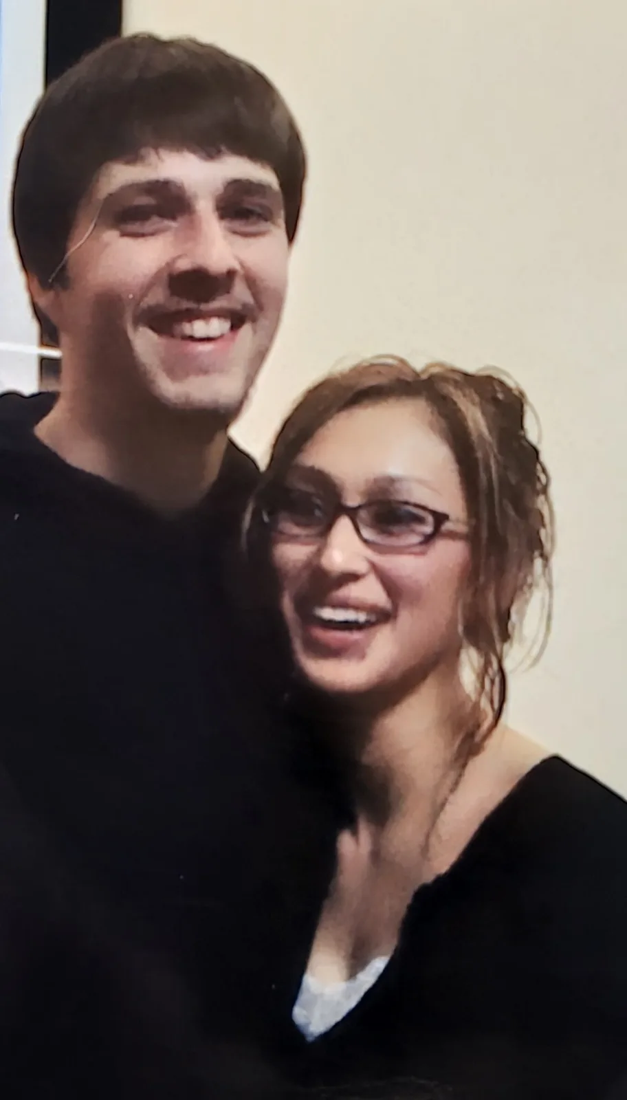 Ken and Francesca in their early twenties, smiling and hugging.