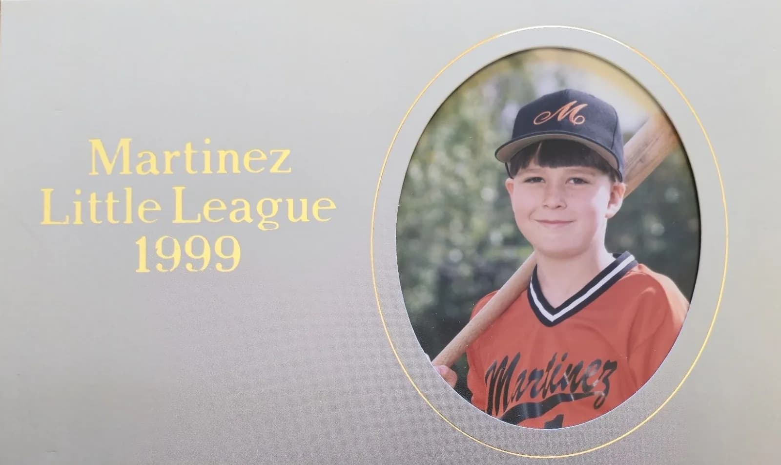 Ken's 1999 Martinez Little League photo card, him in an orange jersey with a bat on his shoulder.